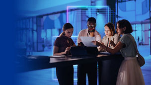 Team reviewing documents in office banner