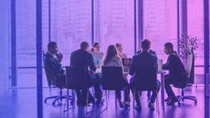 Team sitting in meeting room and discussing something