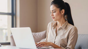 Indian Businesswoman concentrating on laptop tasks in a serene workspace