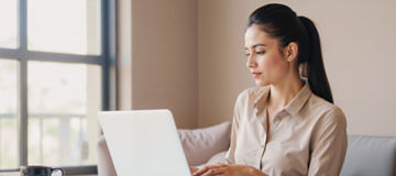 Indian Businesswoman concentrating on laptop tasks in a serene workspace