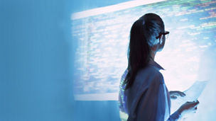 Woman looking at code on an illuminated screen