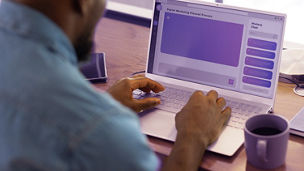 Using ai chatbot on laptop, man working on digital marketing project at home office desk