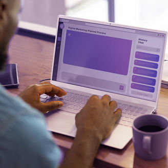 Using ai chatbot on laptop, man working on digital marketing project at home office desk