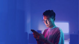 A person looking down at their mobile phone