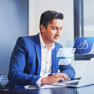 Indian man receiving alert notification in financial fraud protection software on his computer