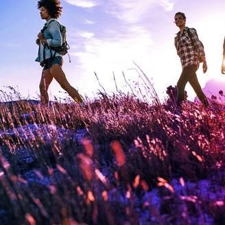 Three friends standing on grass