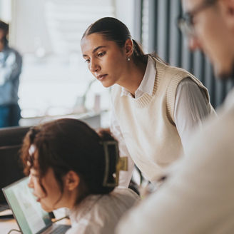 Three peers looking at desktop