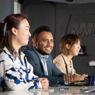 Three people in KPMG office