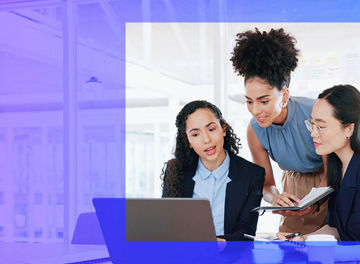 three people looking at laptop