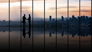 Businesspeople in front of urban cityscape.