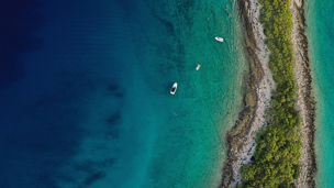 Top-view of sea & island with boats