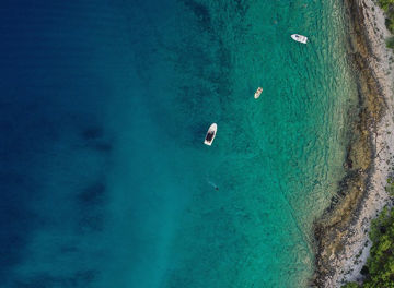 Top-view of sea & island with boats