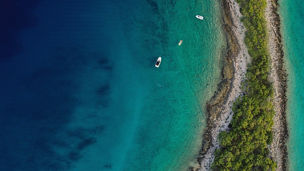 Top-view of sea & island with boats