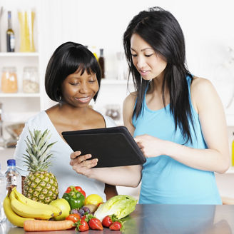 Dietician Showing Client Diet/ Food Plan On A Digital Tablet