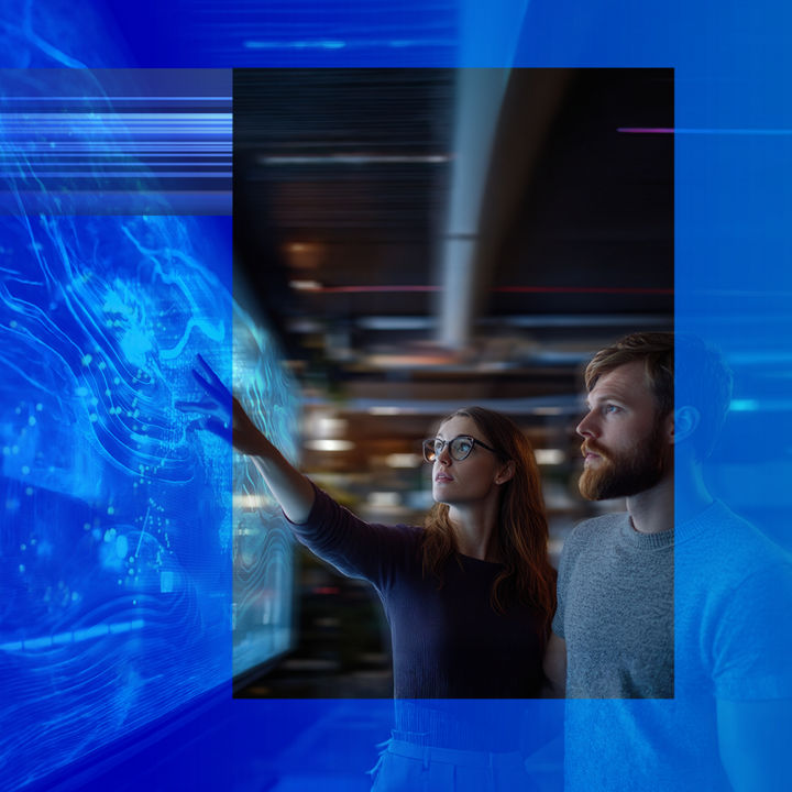 Colleagues surrounding a high definition touch screen