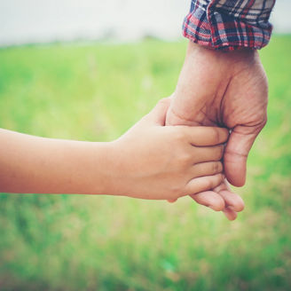 Close up of father holding his daughter hand, so sweet,family time.