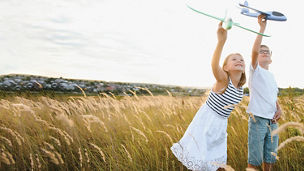 Two children holding an aeroplane