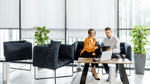 two-colleagues-discussing-on-couch