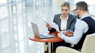 Two collegues discussing the business documents
