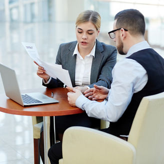 Two collegues discussing the business documents