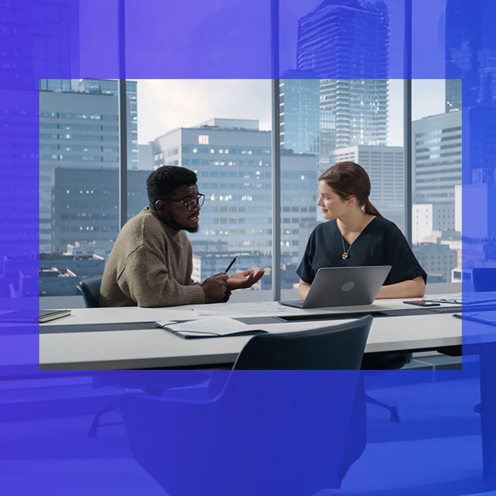 Two coworkers having discussion in office