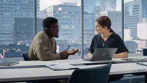 Two coworkers having discussion in office