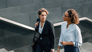 Two Female colleagues climbing stairs