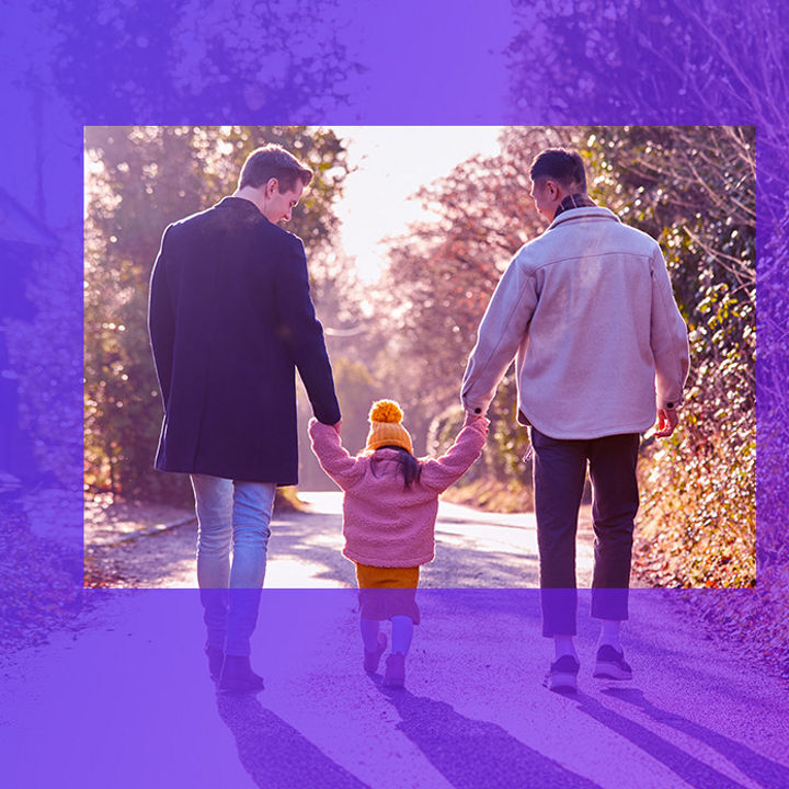 Two men and a girl walking holding hands banner
