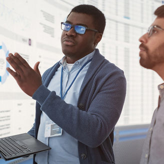 Two men looking at digital dashboards