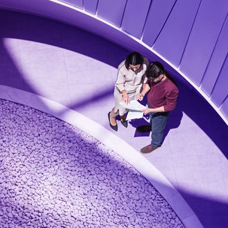 two people looking at papers near rocks