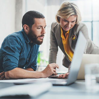 two-people-looking-at-the-laptop