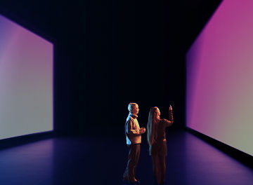 Two people looking at wide screen
