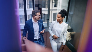 Two people talking in office