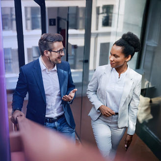 Two people talking in office