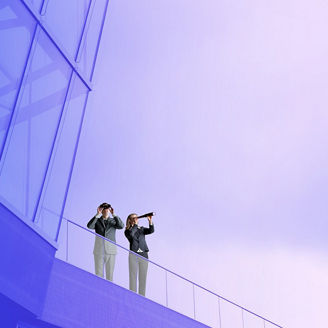 Two people using binoculars