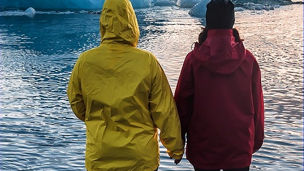 two-people-watching-floating-icebergs