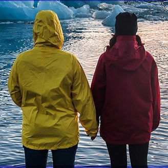 Two people watching floating icebergs