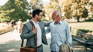 Two professionals having a business conversation while walking in a park
