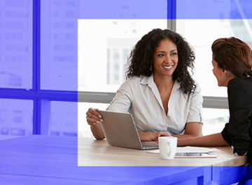 two-women-discussing-on-laptop-image-banner