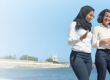 Two women walking and talking