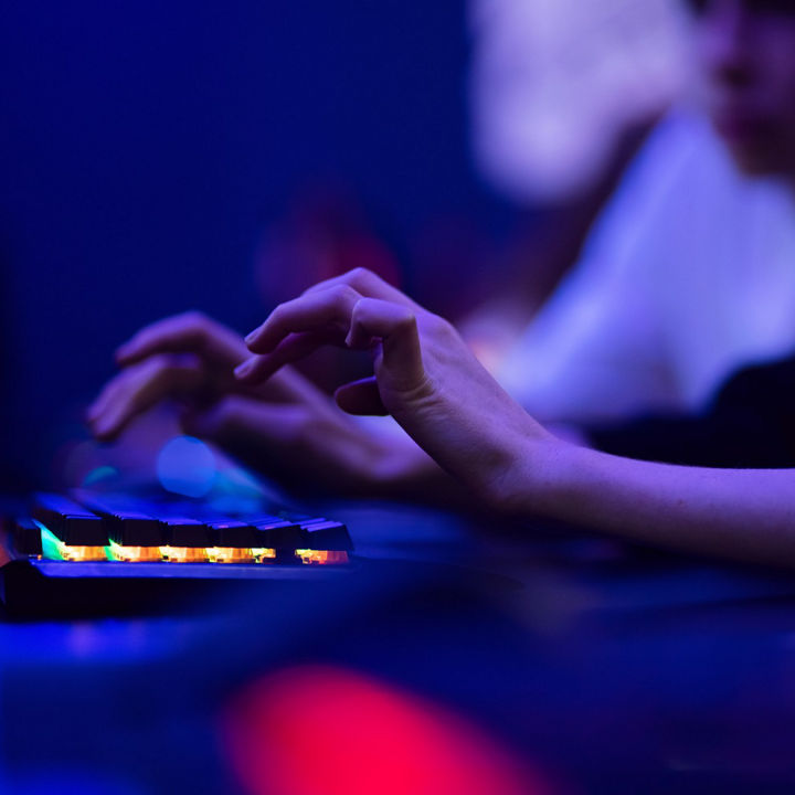 Hacker uses keyboard, shakes buttons with fingers to crack password. Internet security concept, cyber attack.