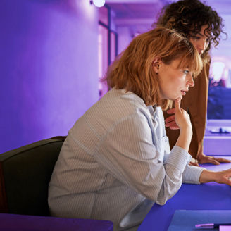 2 women working together on a laptop