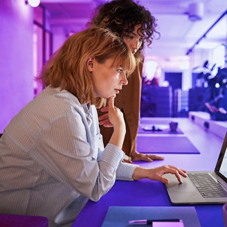 2 women working together on a laptop