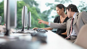 Businesswoman and businessman working on computer