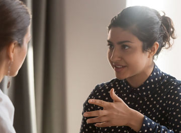 Mentor talking to colleague