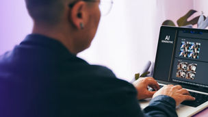 man working on a laptop with AI