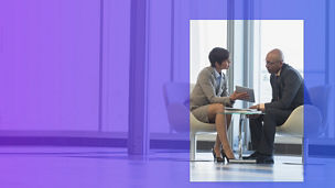 Two people talking while seated