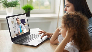 Woman and Child Working on Laptop