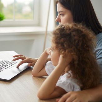 Woman and Child Working on Laptop