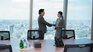 woman-and-man-shaking-hand-in-a-meeting-room.jpg